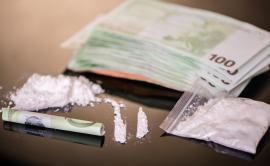 Cocaine and euro banknotes on a table surface